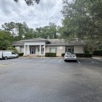 Transformation Dentistry clinic exterior with parking lot and trees